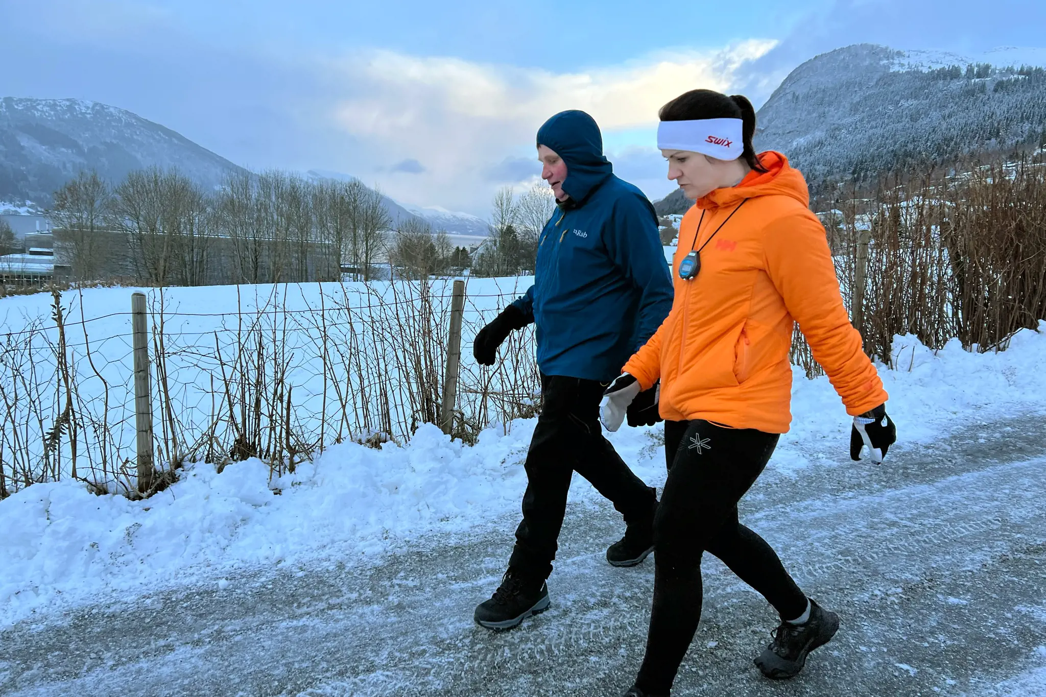 ein mann og ei kvinne går tur utandørs på vinterføre